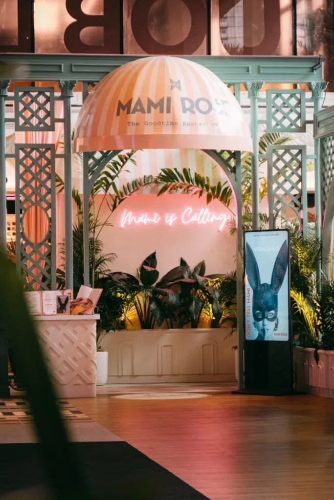 entrance of Mami Rose restaurant in Bangkok with the neon sign Mami is Calling